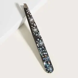 Decorative crystal-pattern slant tweezers with precision stainless steel tip on a white background