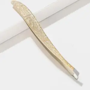 Gold glitter slant tip tweezers for precise eyebrow grooming on a white background